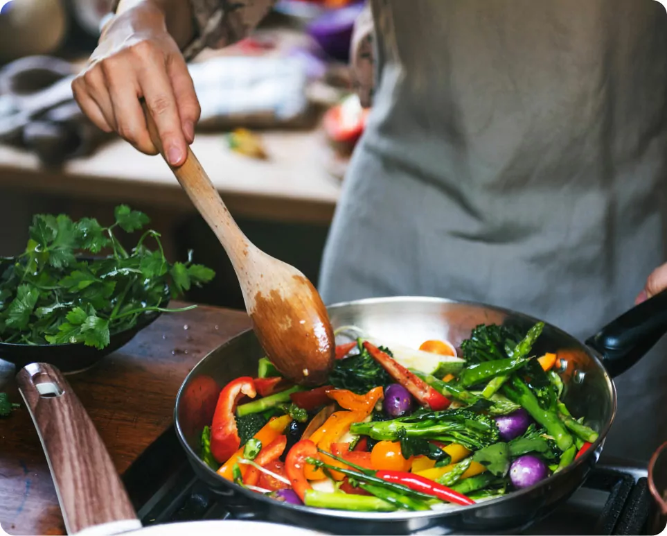 Person Cooking A Vegetable