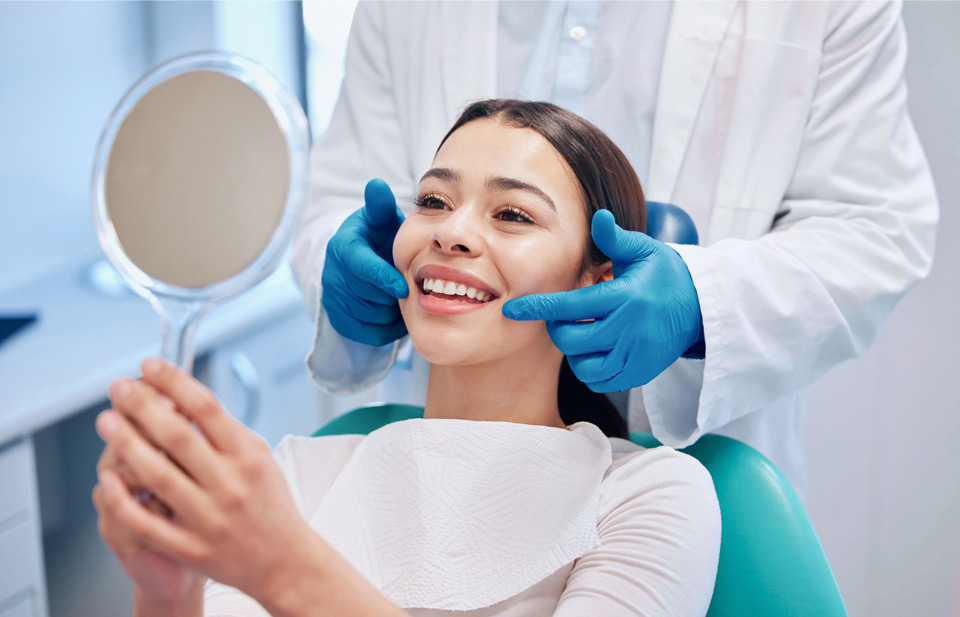 A Dentist Showing A Patient Her Teeth