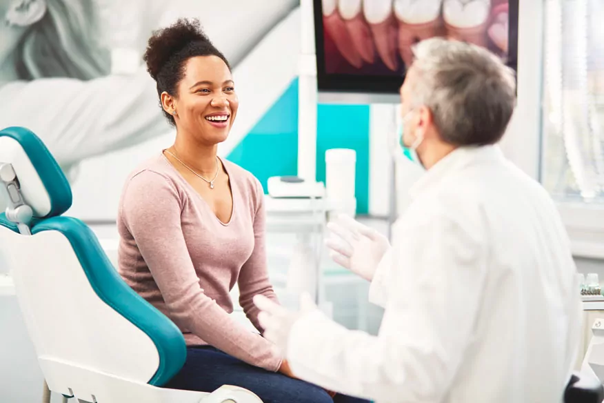 Dentist Talking with Female Patient in Clinic