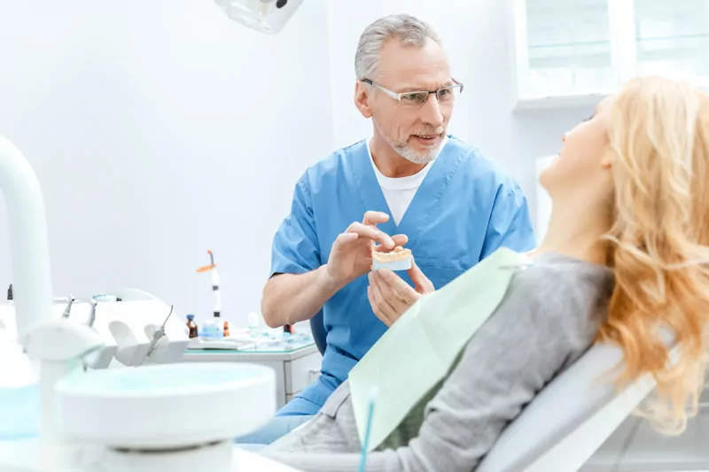 Dentist Treating Female Patient