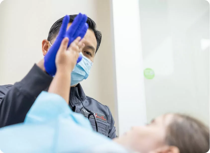 Dentist Giving A High-five To Patient After The Appointment
