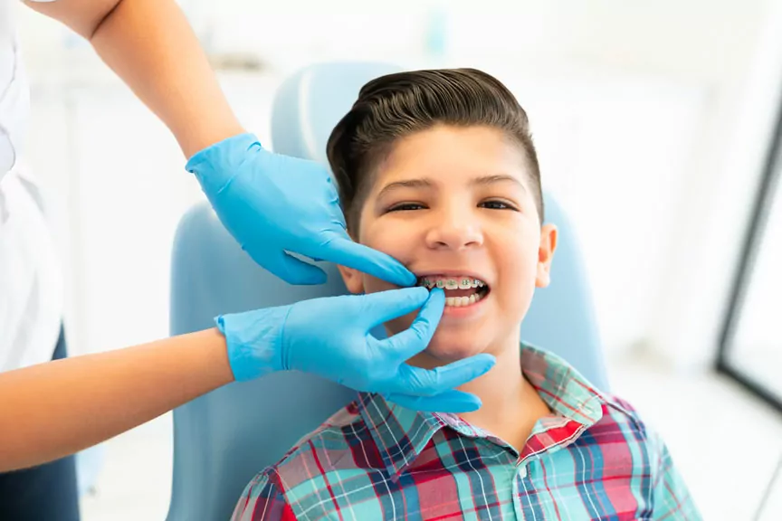 A Boy is Receiving Orthodontic Braces Treatment