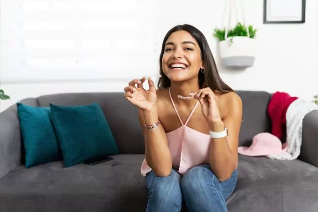 Woman Holding Clear Aligners