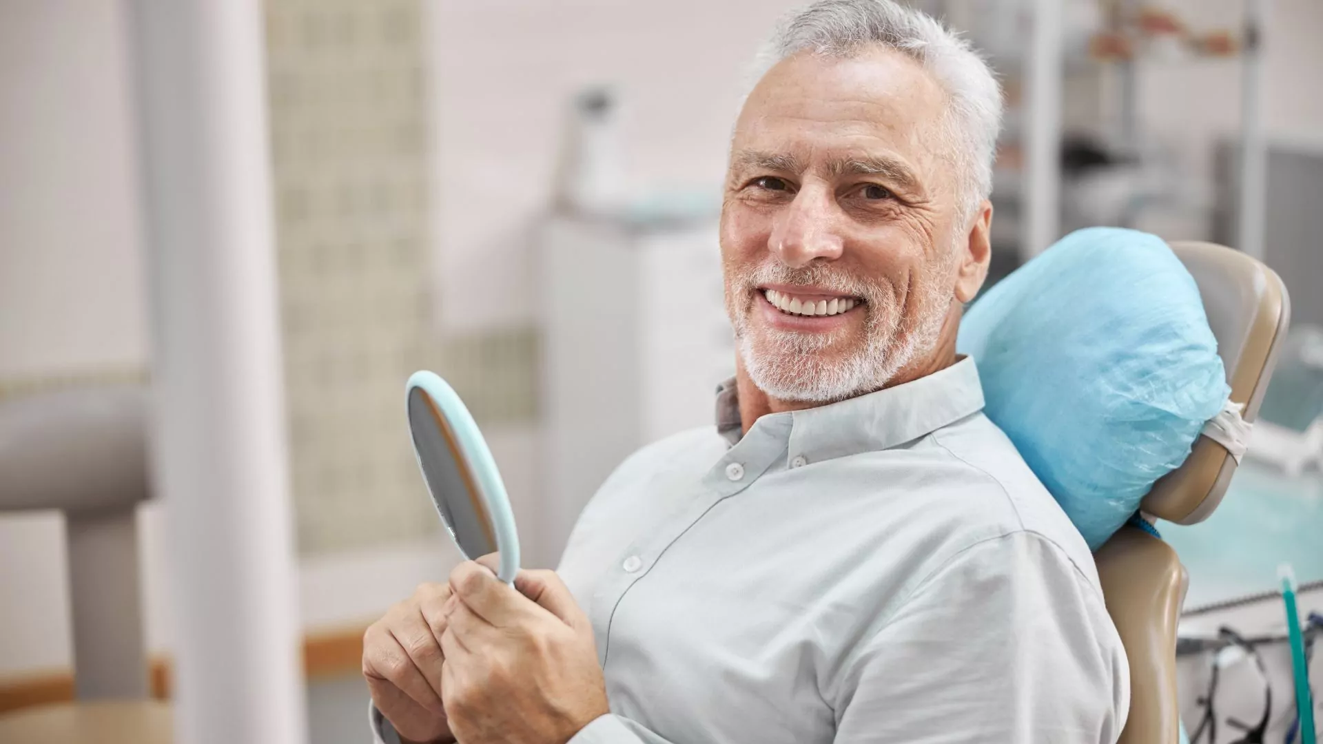 Smiling Senior Man Sitting In A Dental Chair